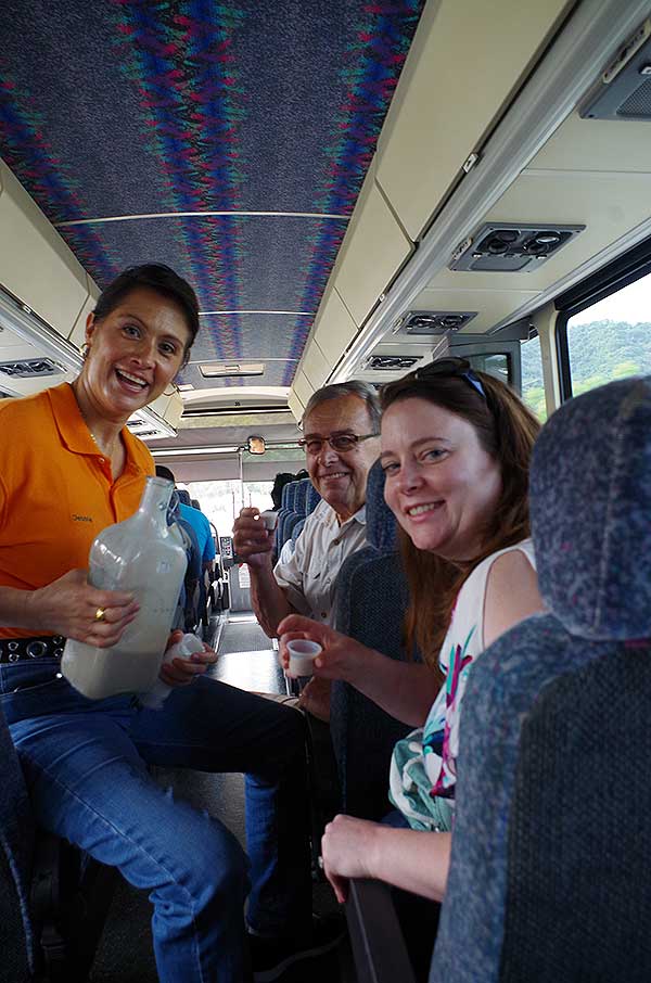 tour guide Debbie with tourist inside a tour bus