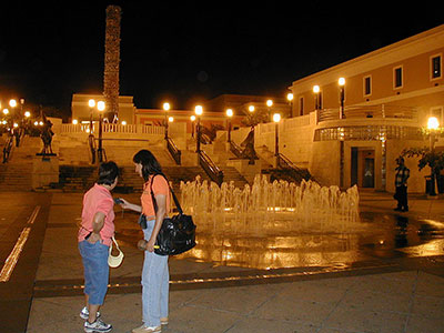 tourists reading a mobile at night in Puerto Rico