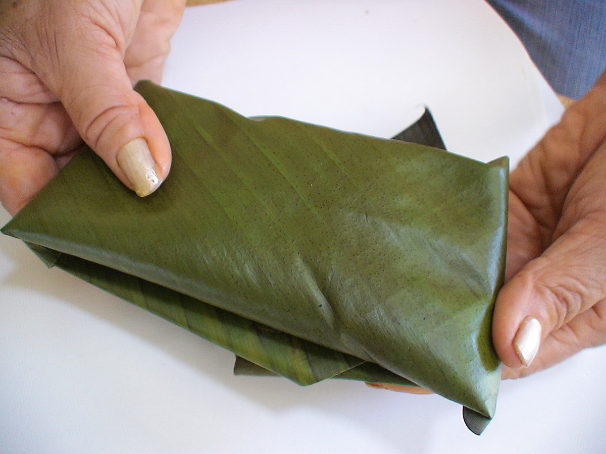 Folding the green banana leaf
